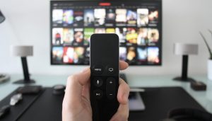 a person holds a remote for streaming tv (1)