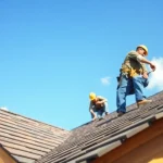 Workers expertly installing roofing materials with Twin Shield Roofing on a sunny day.