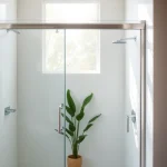 Installing a sliding door shower screen in a stylish bathroom with modern decor.